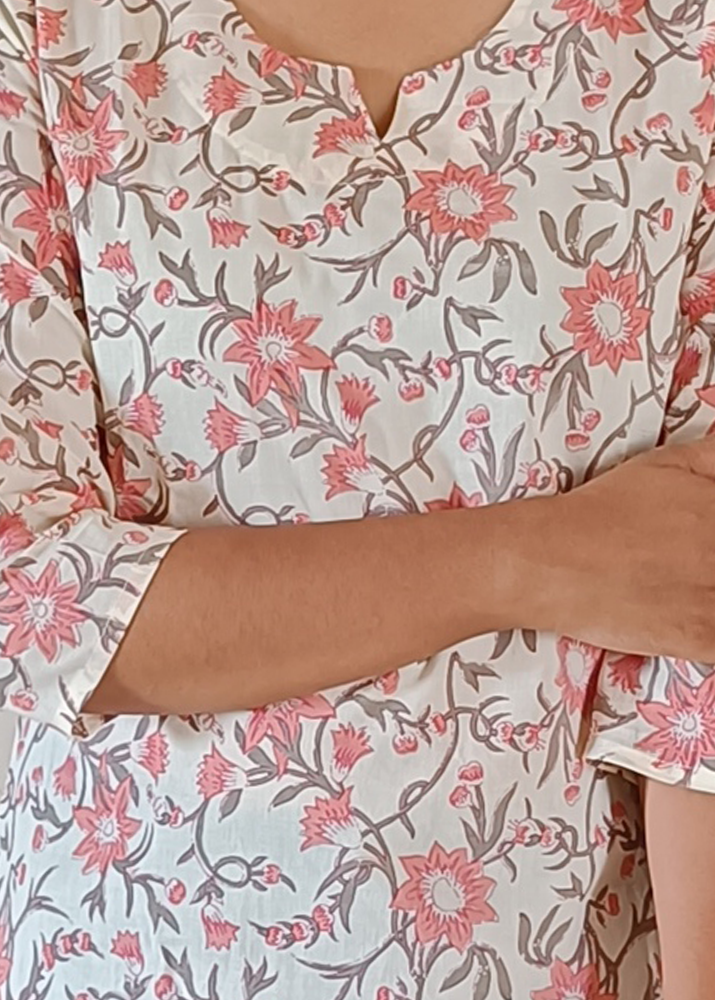 Floral patterned dress with pink and red flowers on a plain background