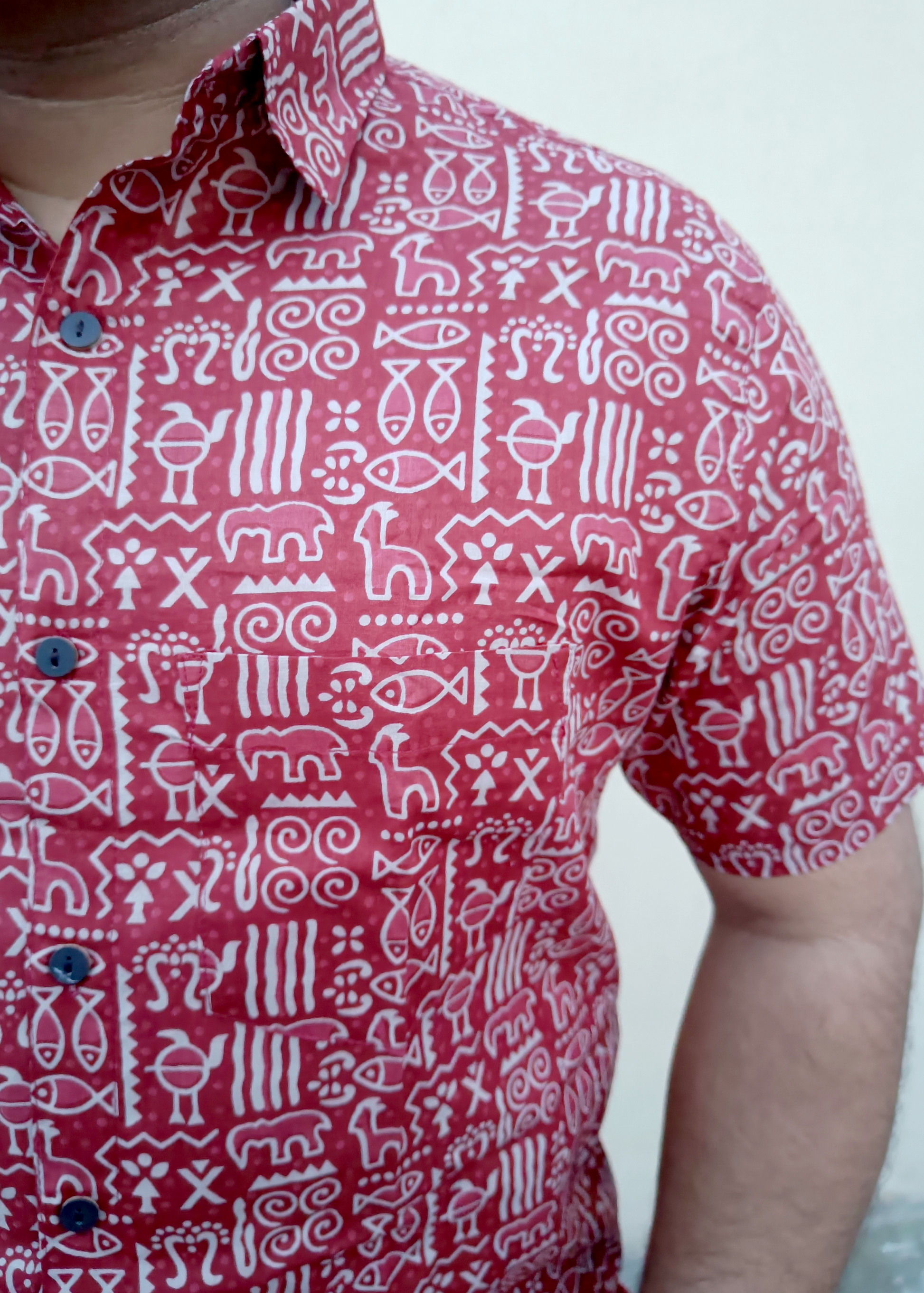 Red shirt with white geometric pattern worn by a person
