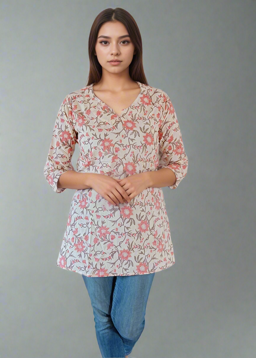 Woman wearing a floral blouse and blue jeans on a white background