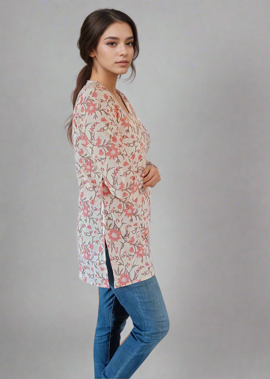 Woman wearing a floral long shirt and blue jeans on a plain background