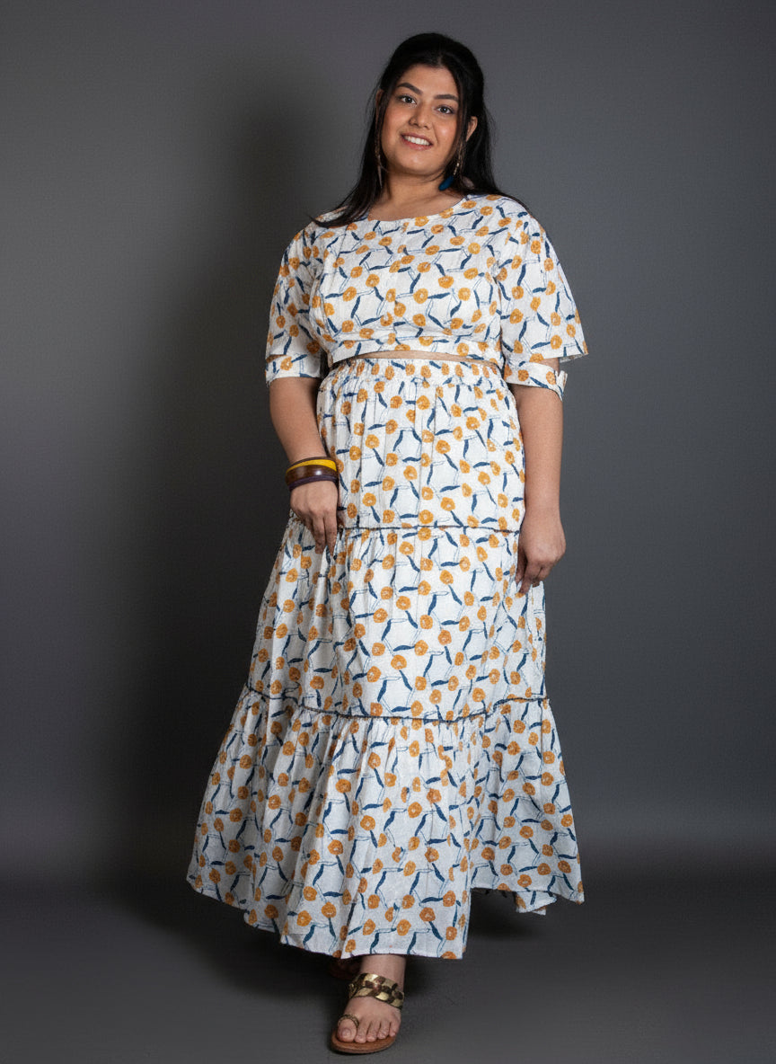 Woman wearing a patterned dress against a gray background