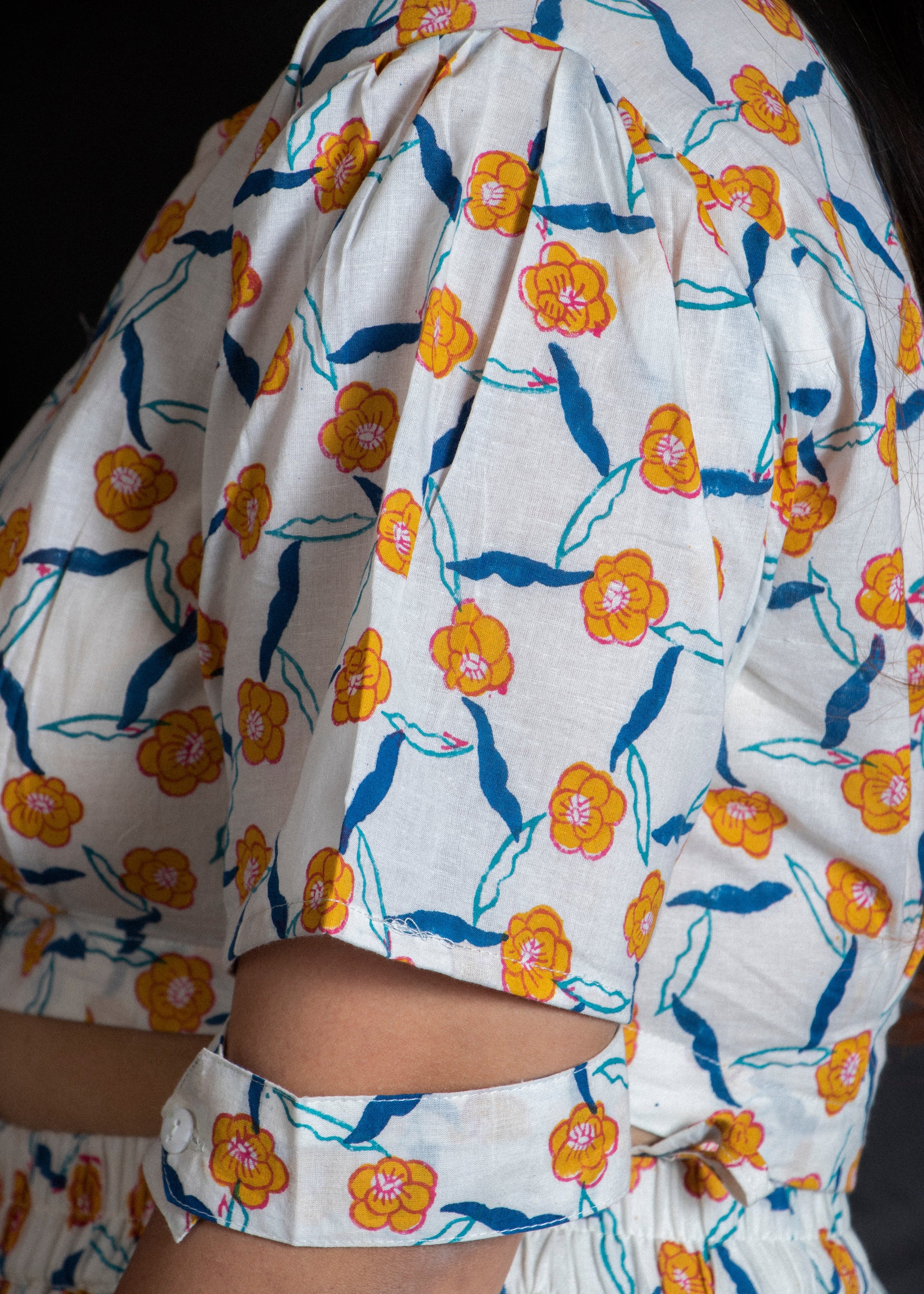 Floral patterned garment with orange and blue flowers on a white background