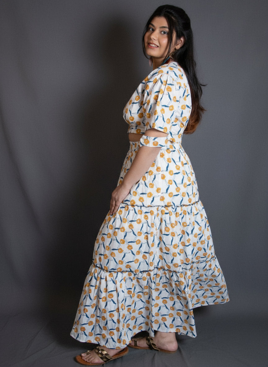 Woman in a patterned co-ord set of a blouse and a skirt