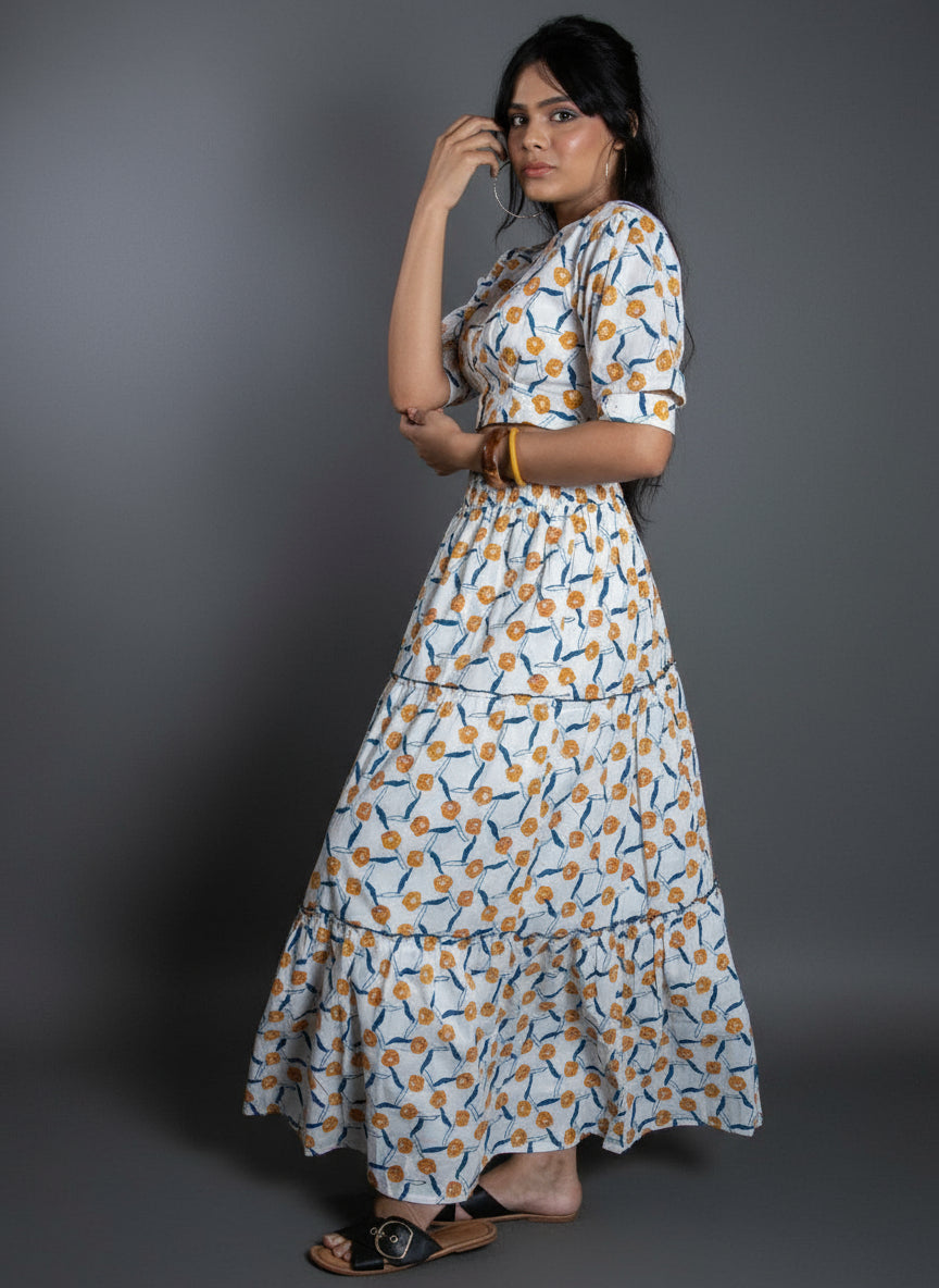 Woman wearing a patterned dress against a gray background
