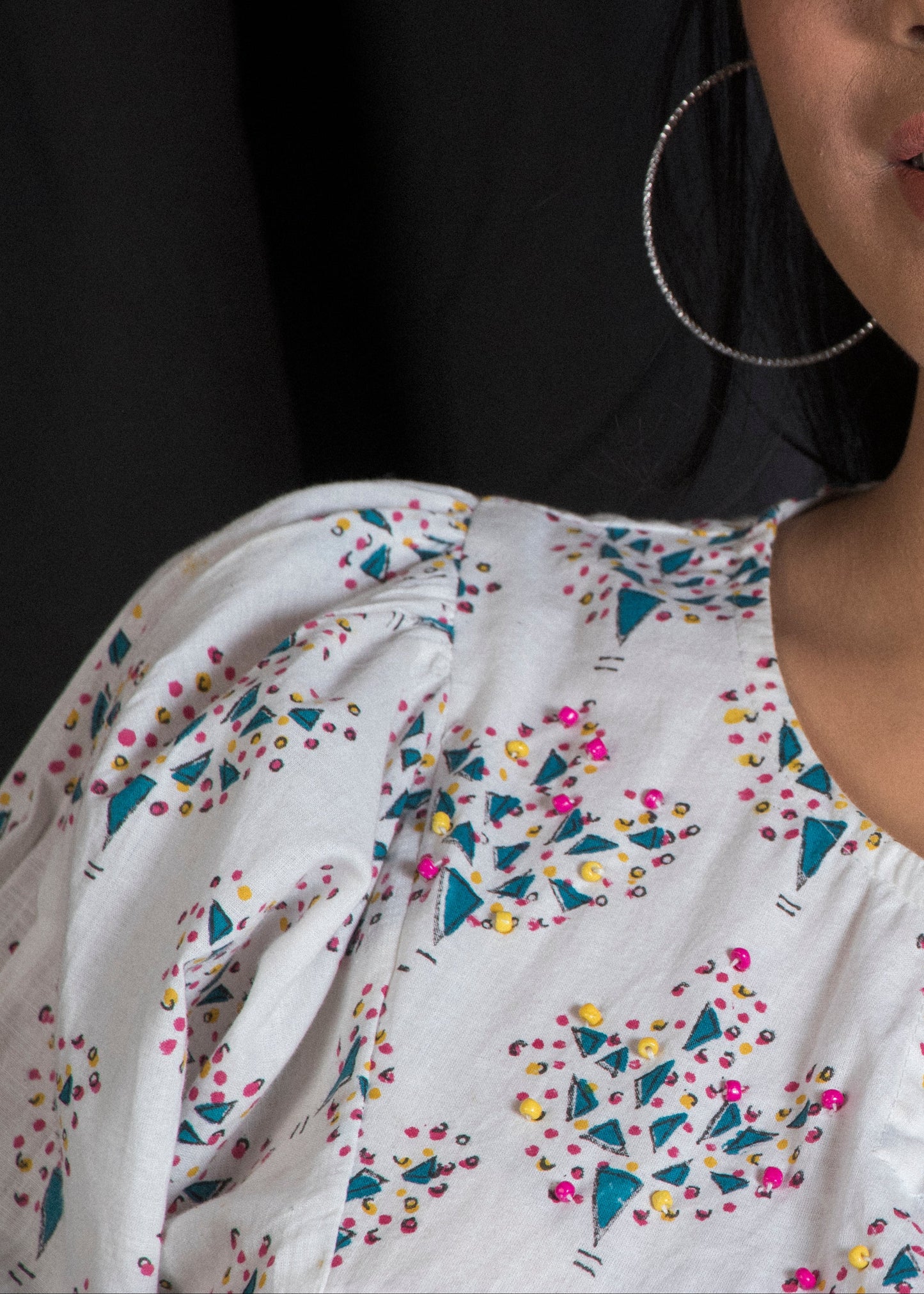 Woman wearing a white dress with colorful tree patterns handblock print