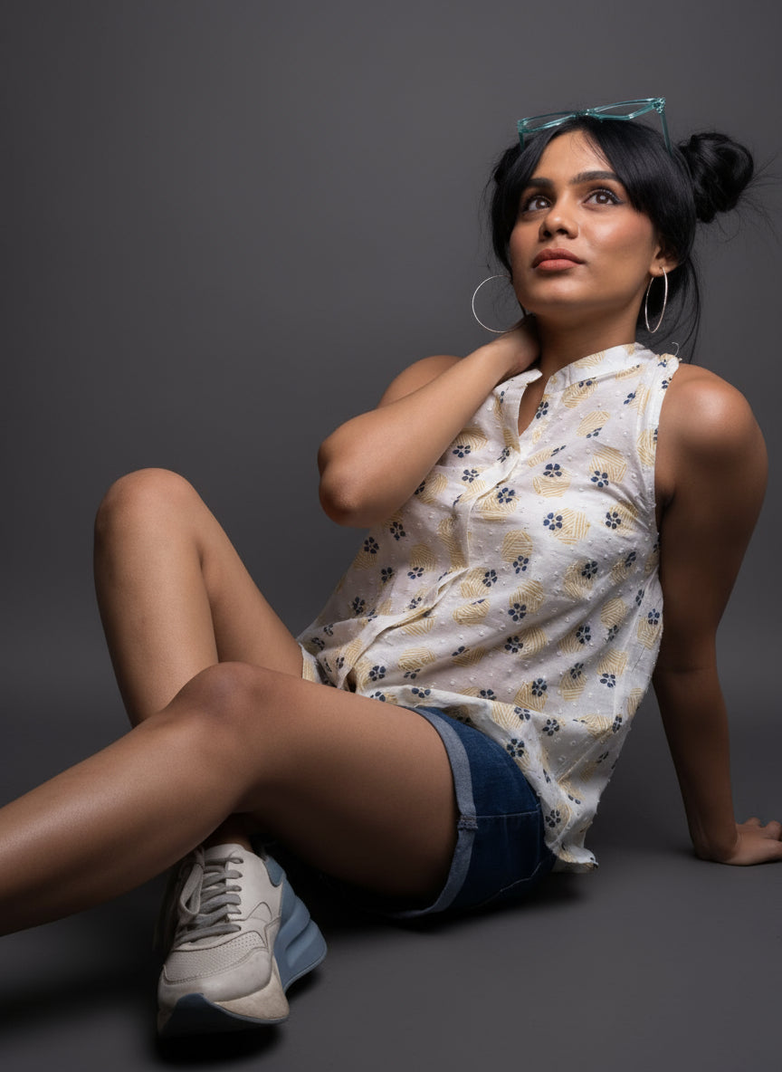 Woman sitting on a dark surface in a Handblock Halter nech shirt top blouse