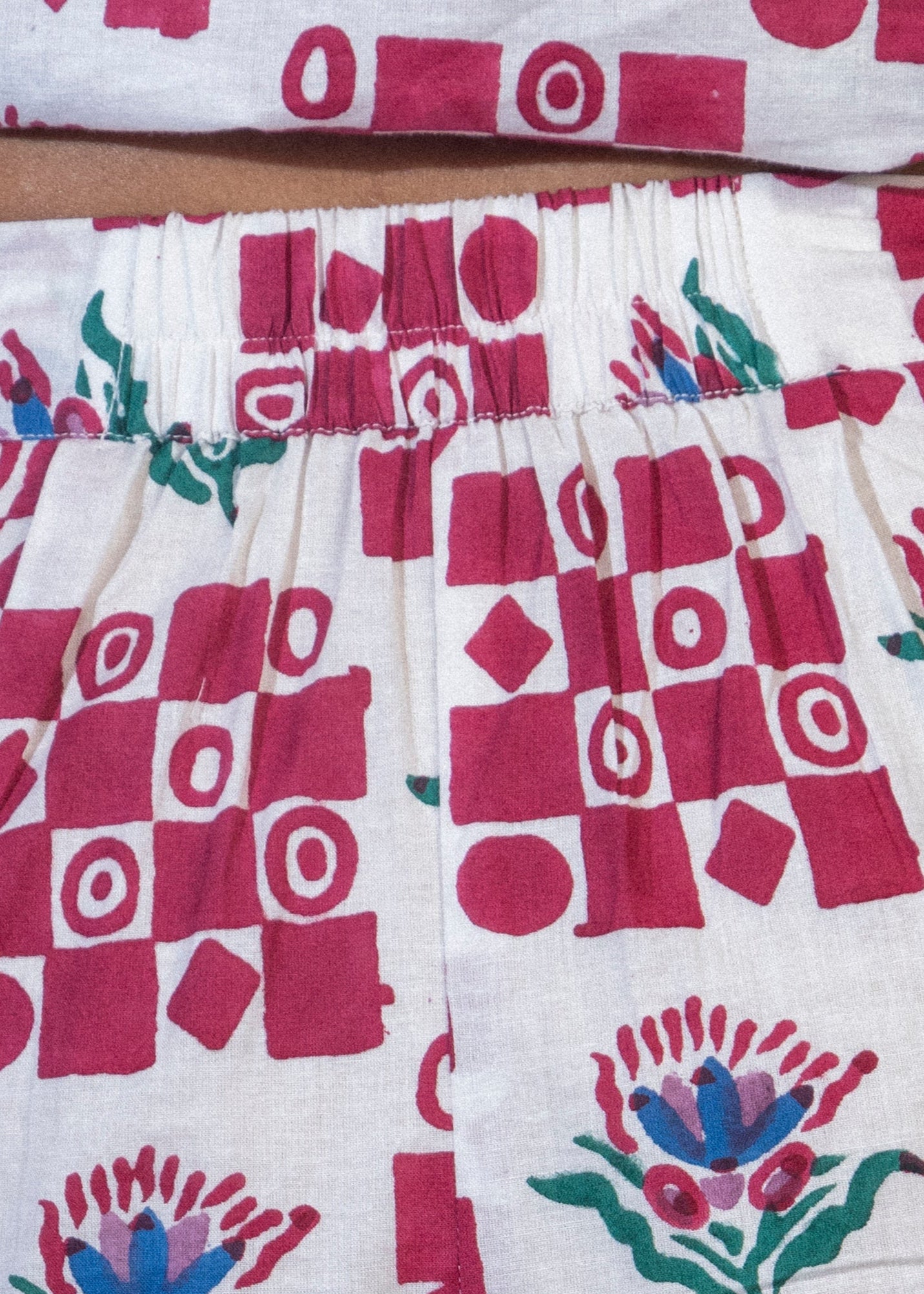 Shorts with a red and white geometric pattern on a dark background