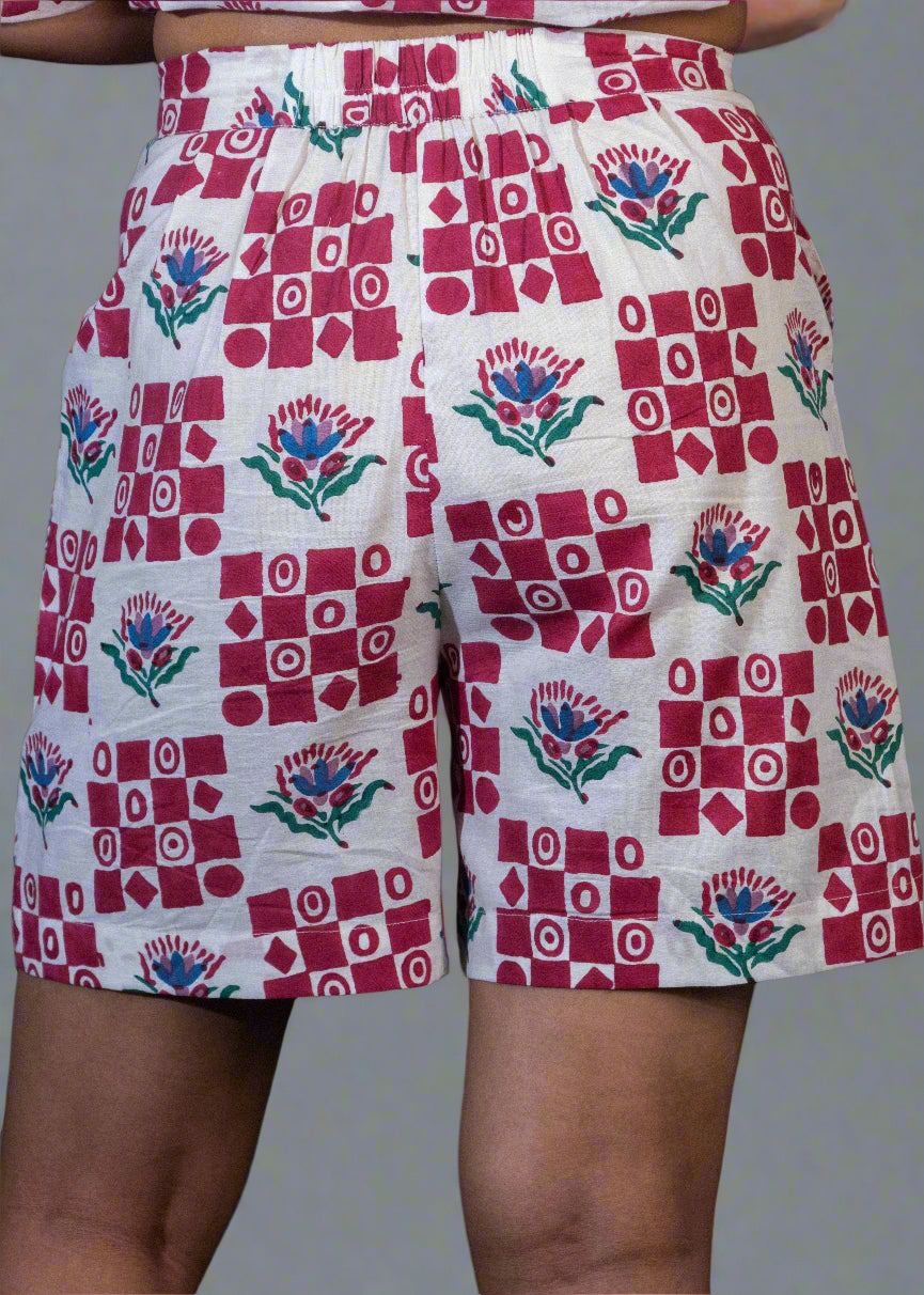 Shorts with a red and white geometric pattern on a dark background