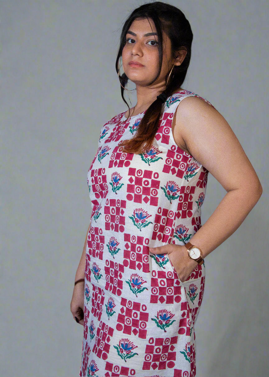 Woman wearing a patterned dress against a dark background