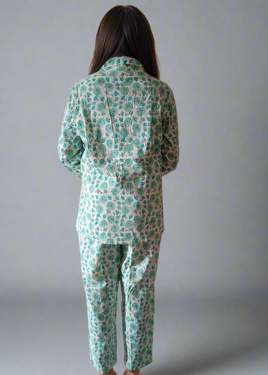 Person wearing a green floral pajama set against a plain background