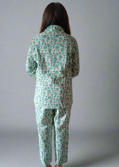 Person wearing a green floral pajama set against a plain background