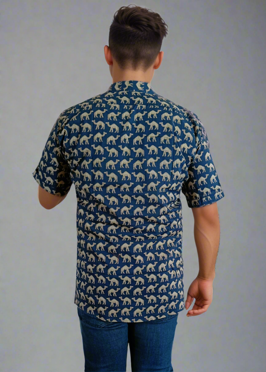 Person wearing a blue patterned shirt and jeans on a white background