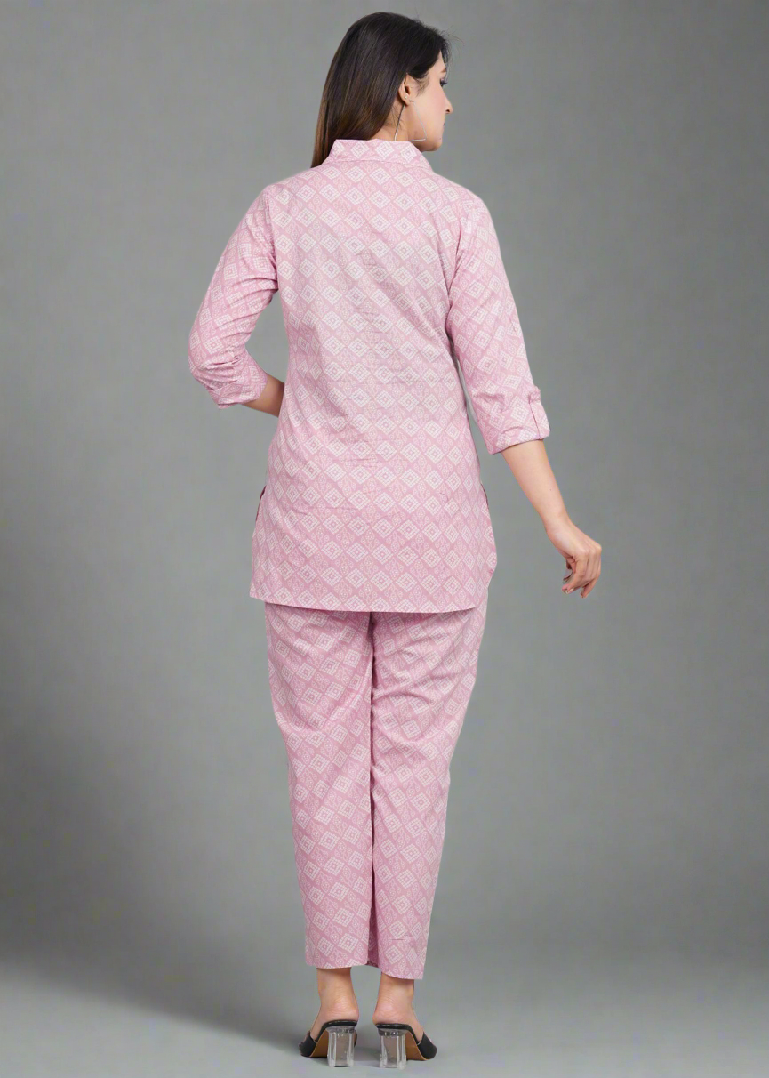 Woman wearing a pink patterned outfit on a gray background