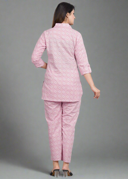 Woman wearing a pink patterned outfit on a gray background