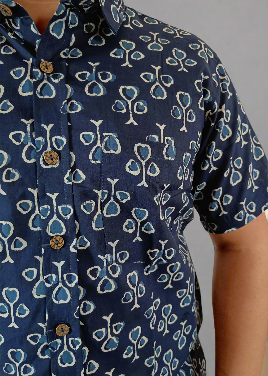 Navy blue shirt with white and light blue floral pattern on a plain background