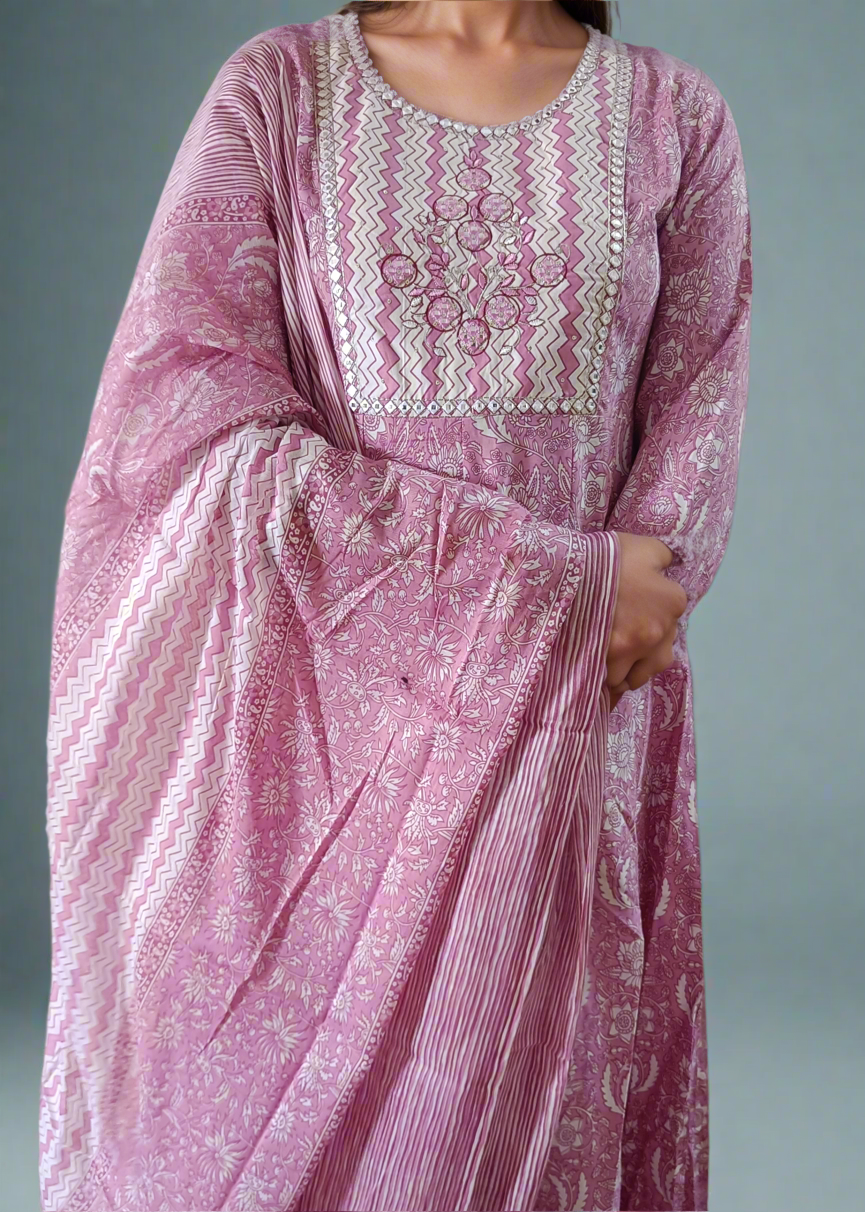 Pink embroidered traditional outfit with a plain background