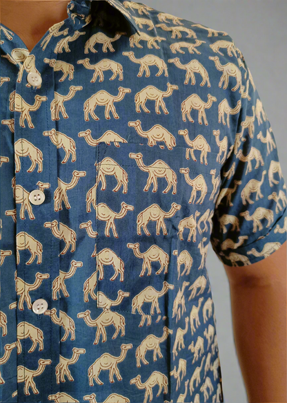 Blue shirt with beige camel pattern worn by a person