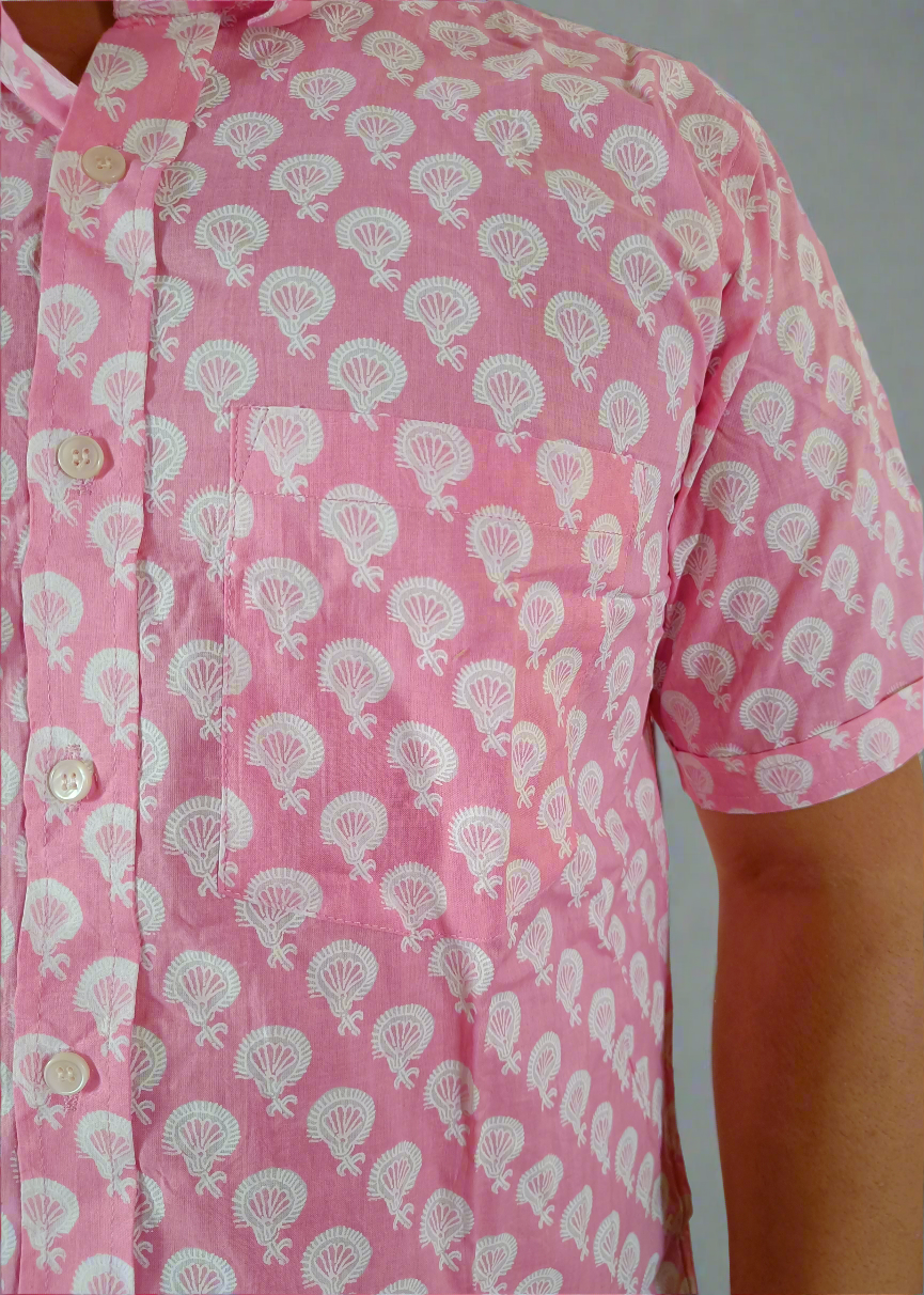 Pink shirt with white floral pattern worn by a person