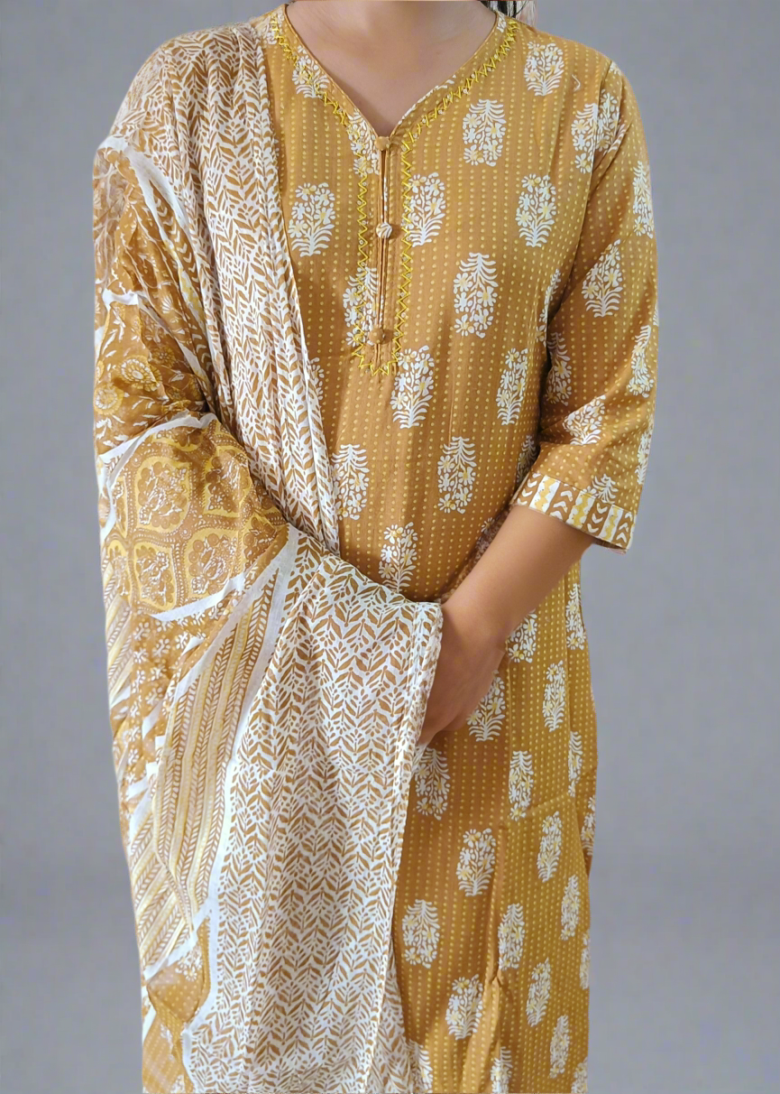 Yellow patterned kurta with white dupatta against a neutral background