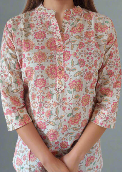Floral patterned tunic shirt top worn by a person on a plain background