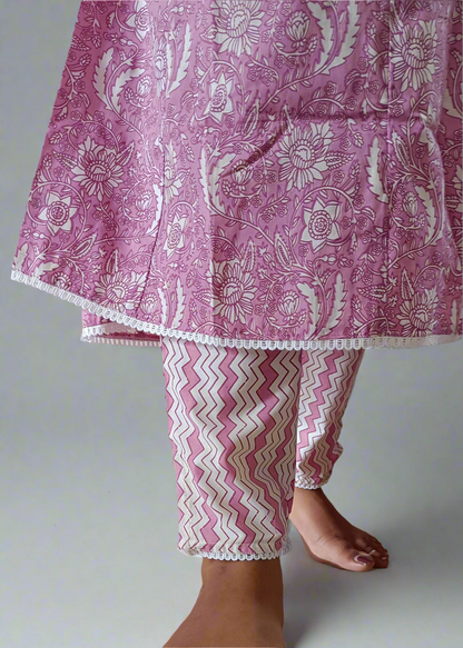 Pink and white patterned outfit on a neutral background