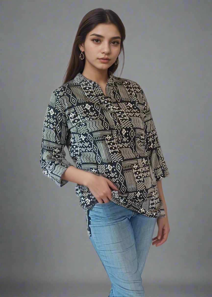 Woman wearing a patterned shirt, blue jeans, and white sneakers on a plain background