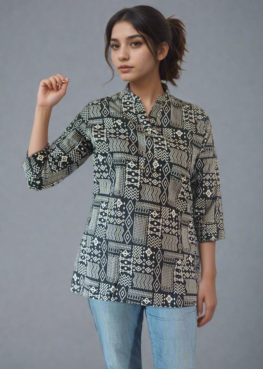 Woman wearing a patterned shirt and jeans against a plain background