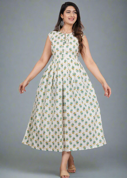 Woman wearing a white dress with green floral pattern on a gray background