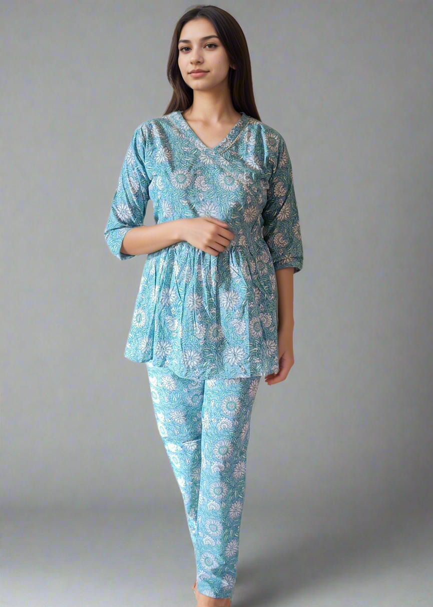 Woman wearing a blue floral pajama set against a plain background