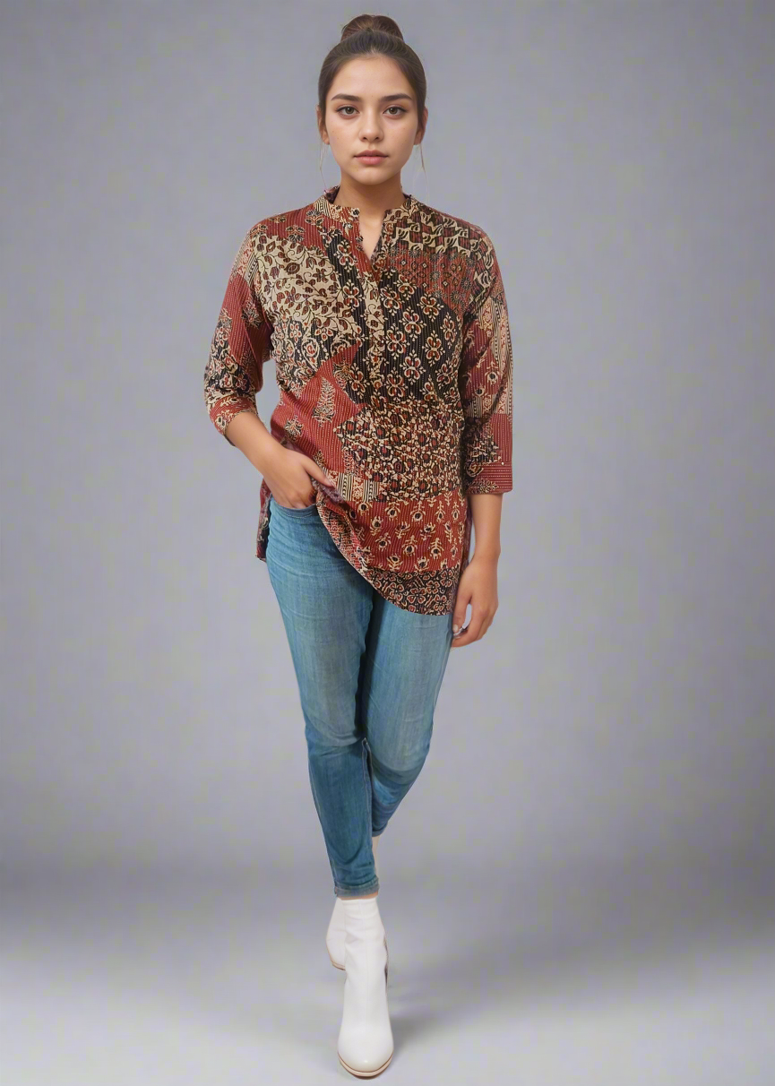 Woman wearing a patterned shirt and jeans on a white background