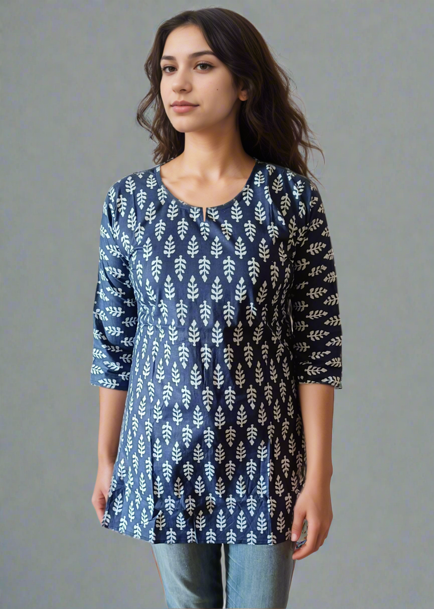 Woman wearing a blue patterned tunic kurti and jeans on a plain background