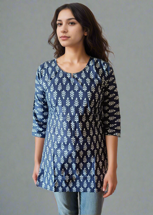 Woman wearing a blue patterned tunic kurti and jeans on a plain background