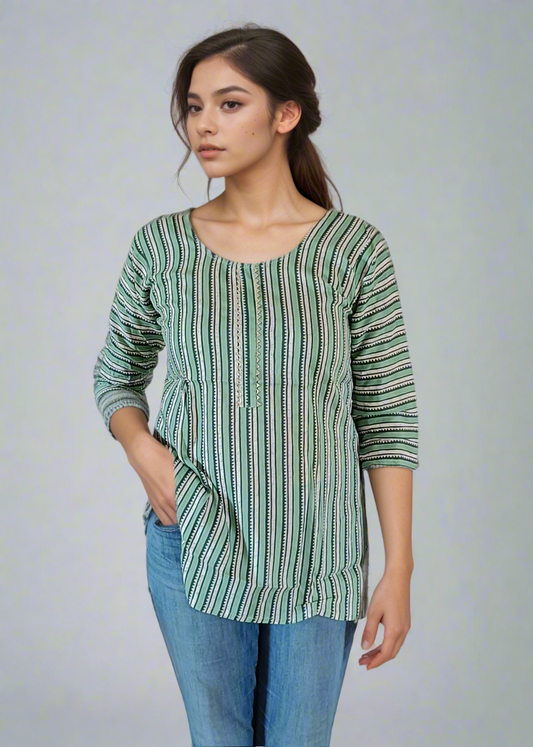 Woman wearing a green striped shirt and blue jeans on a plain background