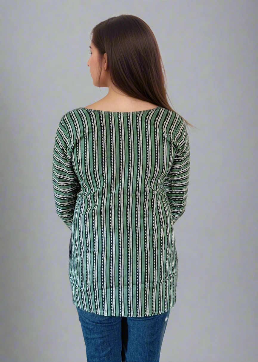 Woman wearing a green and white striped top and blue jeans on a white background