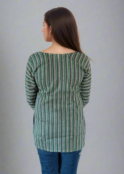 Woman wearing a green and white striped top and blue jeans on a white background