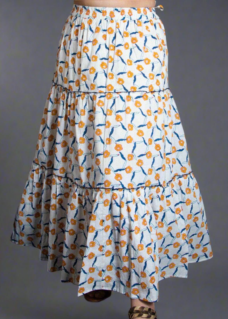 Woman in a patterned floral block print skirt.