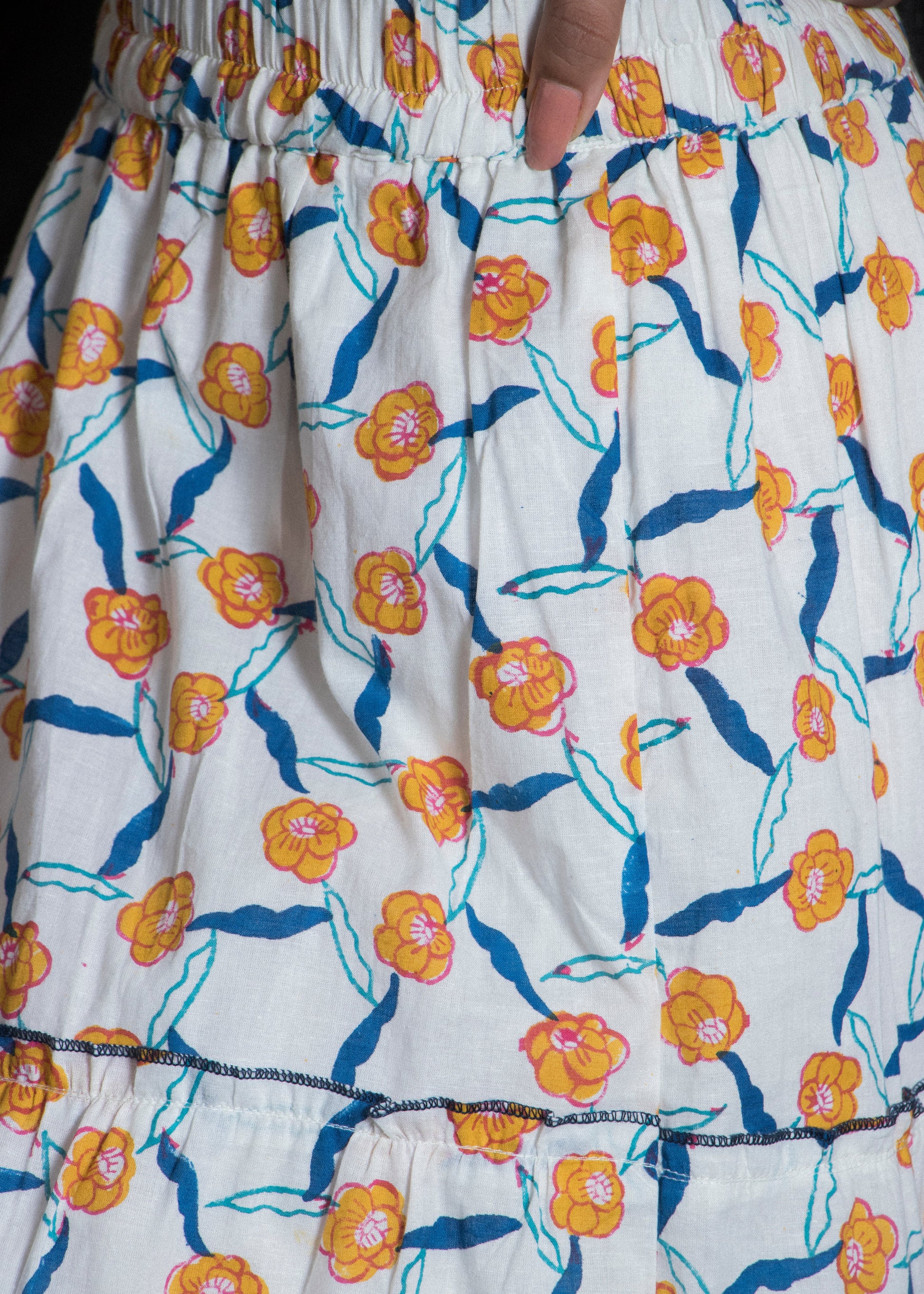 Floral patterned fabric with orange flowers on a white background