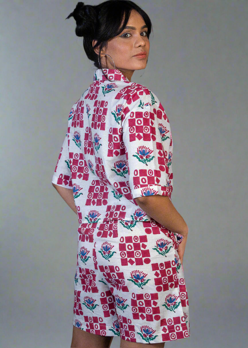 Woman wearing a patterned dress against a dark background