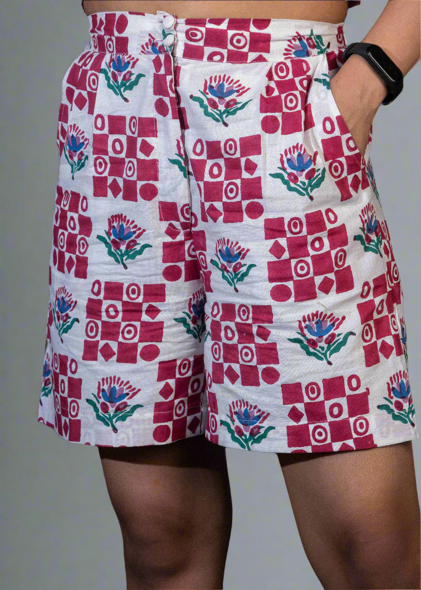 Person wearing a patterned shorts with red, white, and blue design on a dark background