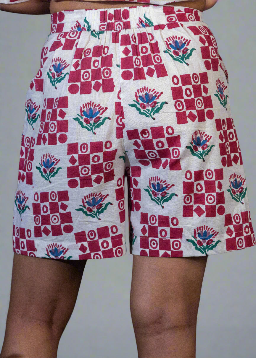 Shorts with a red and white geometric pattern on a dark background