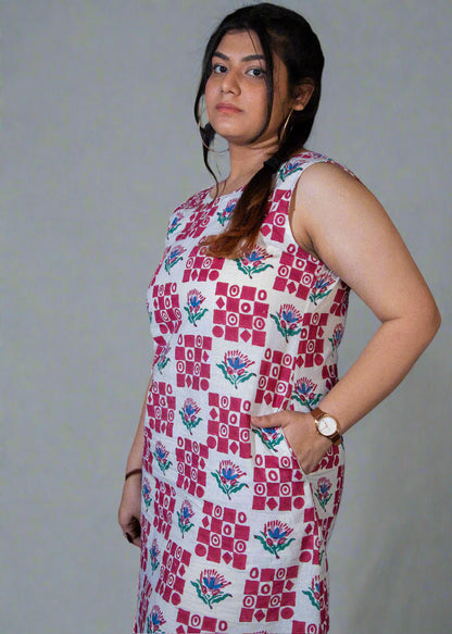Woman wearing a patterned dress against a dark background