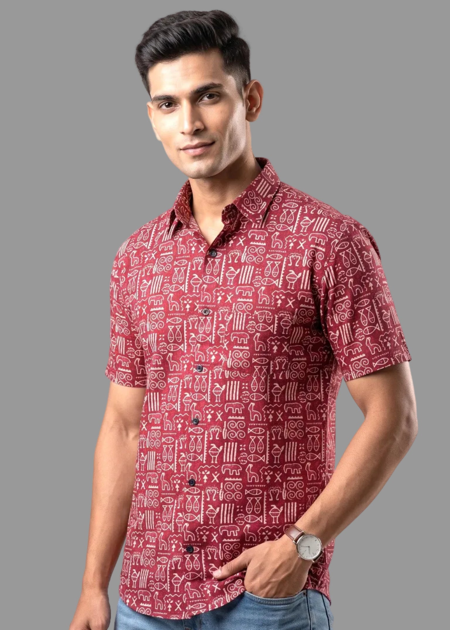 Man wearing a red patterned shirt on a gray background