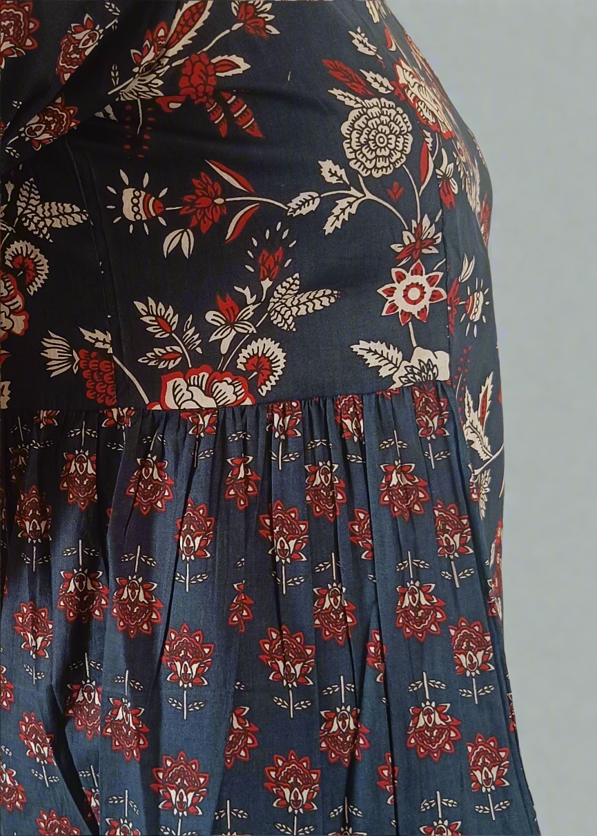 Floral patterned dress with red and white flowers on a blue background