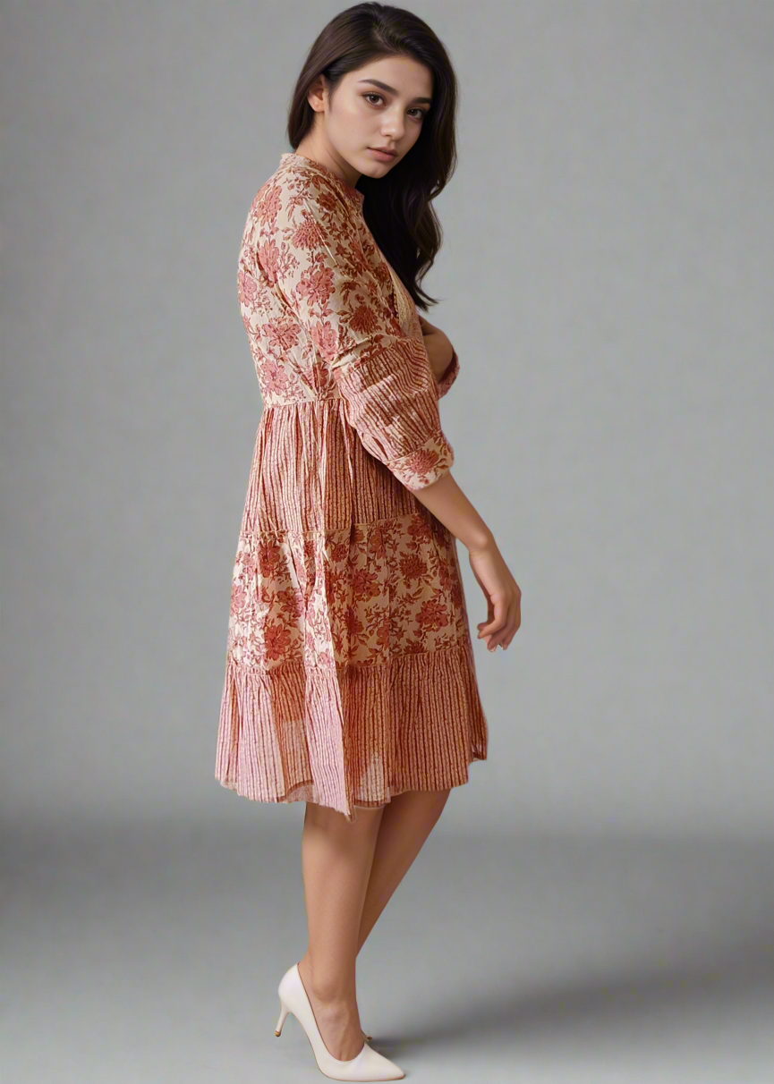Woman wearing a floral stripe dress against a plain background