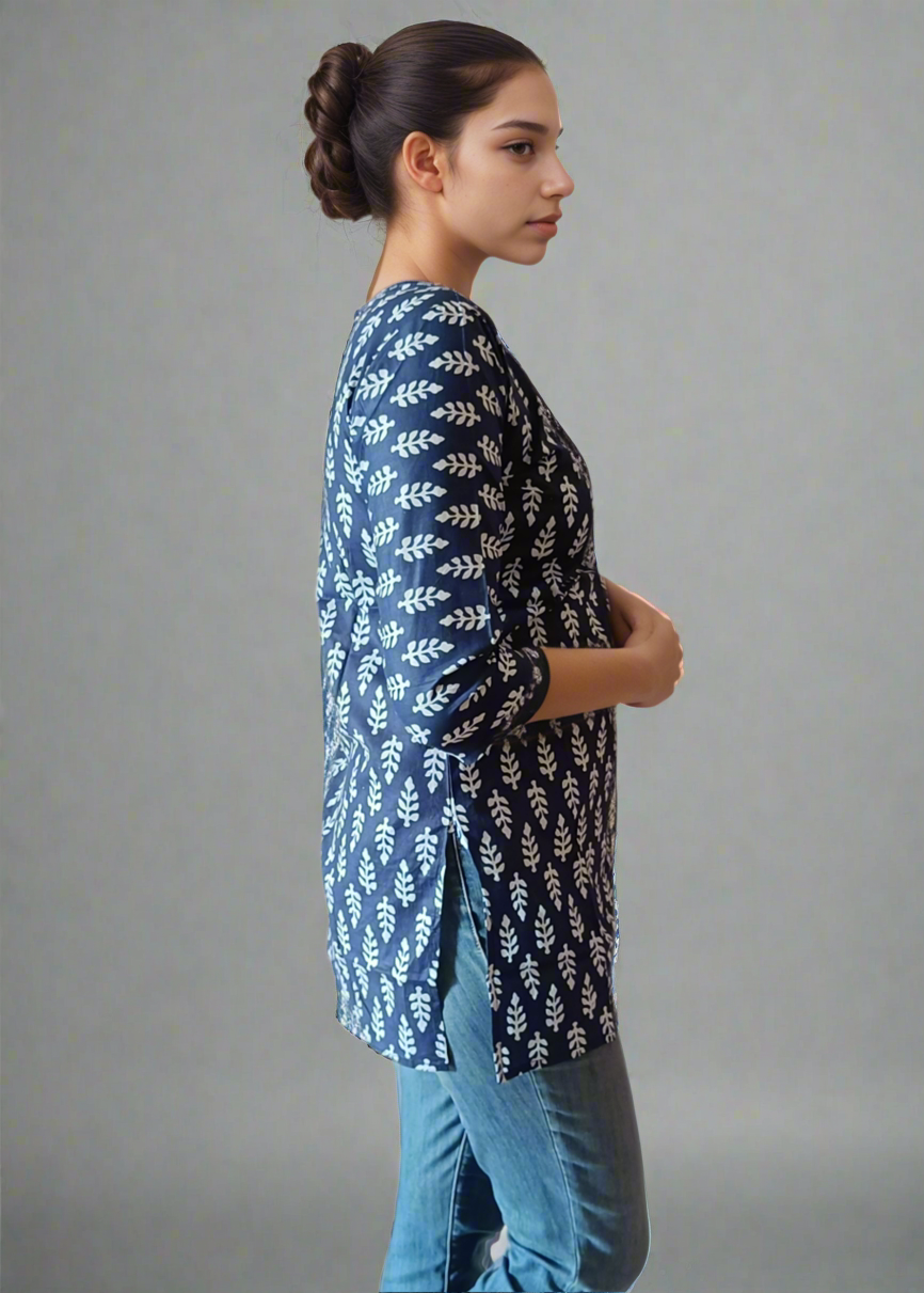 Woman wearing a blue patterned tunic kurti and jeans on a plain background