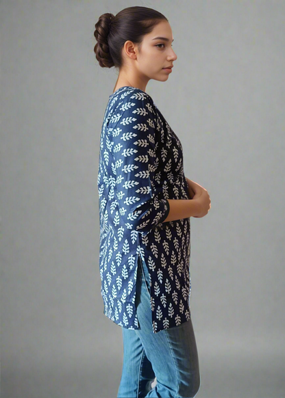 Woman wearing a blue patterned tunic kurti and jeans on a plain background