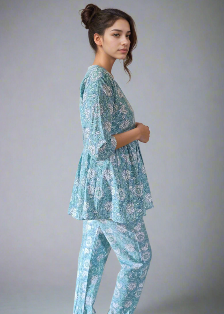 Woman wearing a blue floral pajama set on a plain background