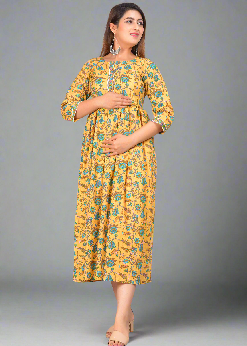 Woman wearing a yellow floral nursing dress on a gray background