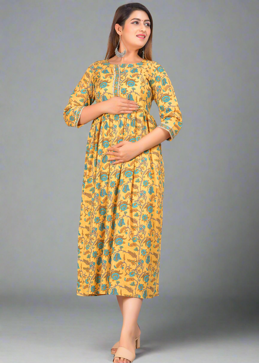 Woman wearing a yellow floral nursing dress on a gray background