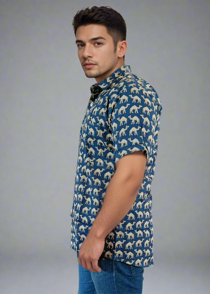 Man wearing a blue patterned shirt and jeans on a white background